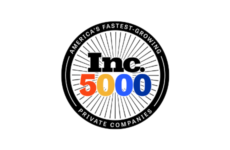 A circular black and white badge with Americas Fastest-Growing Private Companies around the edge and Inc. 5000 in bold black, orange, yellow, and blue letters in the center with radiating lines behind.
