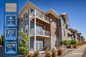 Modern three-story apartment building with balconies, brick and stone exterior, and landscaped walkway. Overlay highlights: A class, 210 units, built in 2019, with 32 Union and BAM Multifamily Consulting Group logos.