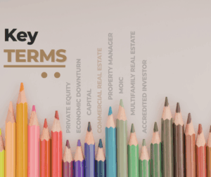 Colored pencils arranged in a row from left to right, with the words Key Terms in bold on the left. Faded finance and real estate terms are listed vertically above the pencils.