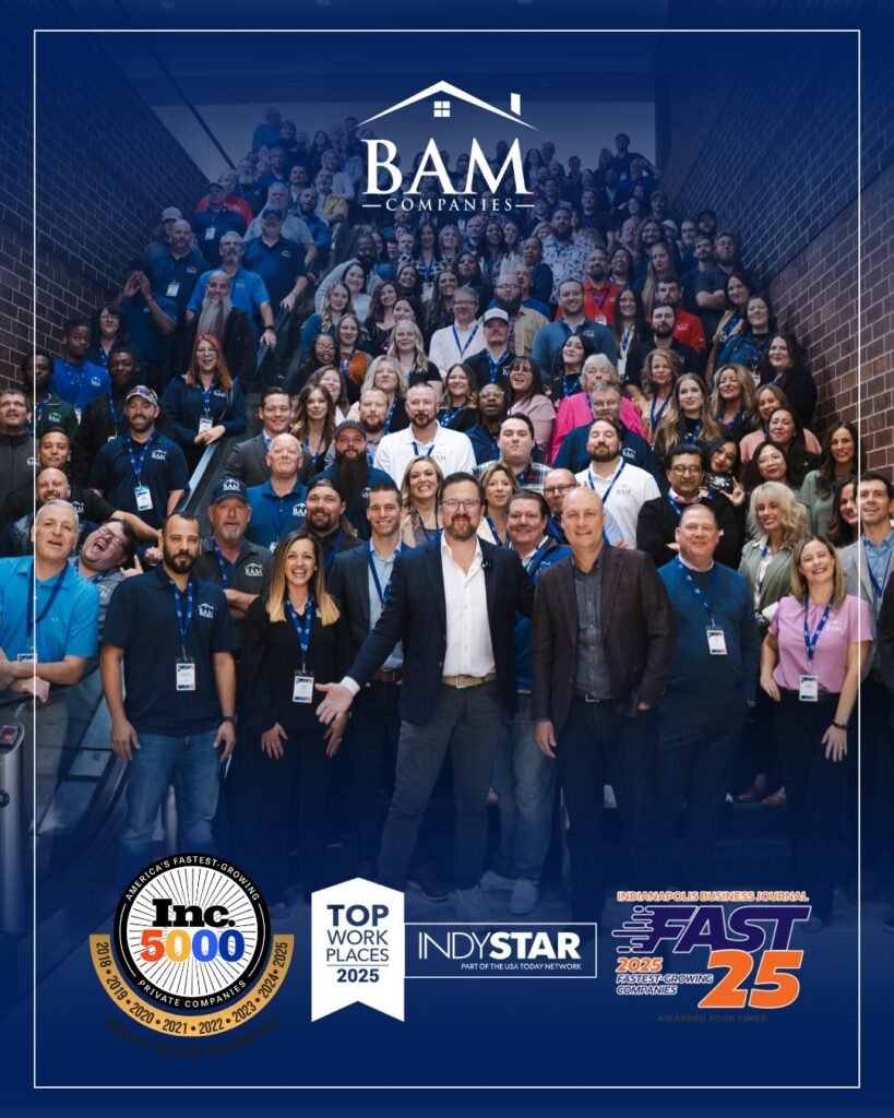 A large group of people pose on a staircase under the BAM Companies logo. Several leaders stand in front. Award badges, including Inc. 5000, Top Workplaces 2025, and Fast 25, are displayed at the bottom of the image.