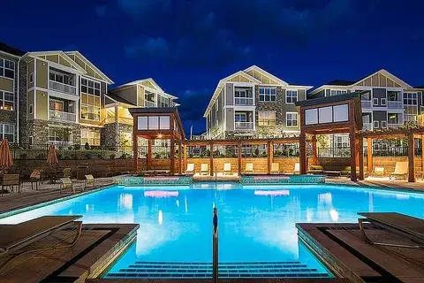 Visual illustrating 2025 multifamily investment returns with modern apartment buildings representing market performance and investment outlook.