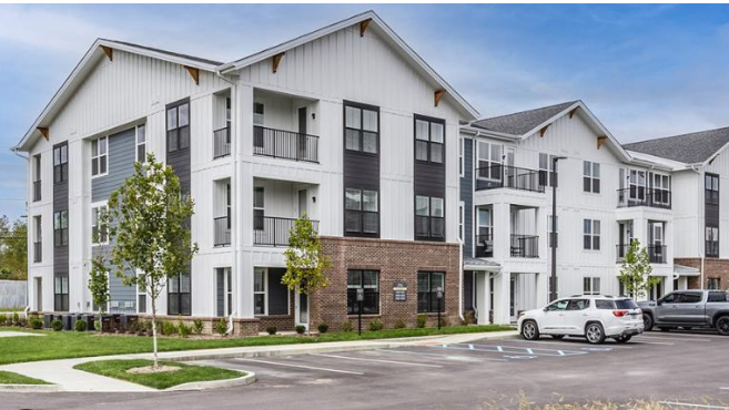 A BAM Capital slide featuring the title accredited investor vs. qualified purchaser, with a photo of a modern multifamily apartment community in Whitestown, Indiana.